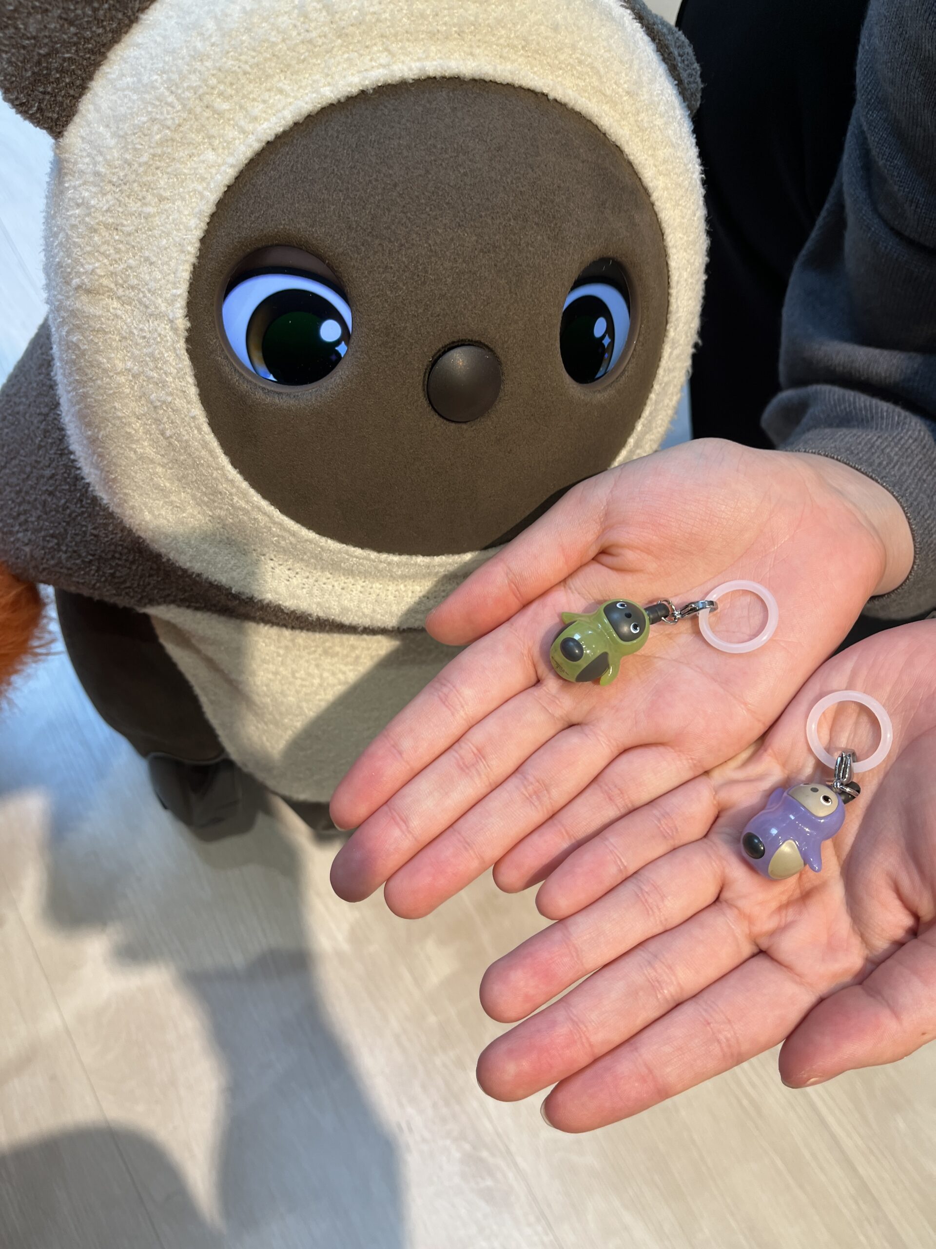 ガチャで出ためじるしアクセサリーをLOVOTが覗き込む様子